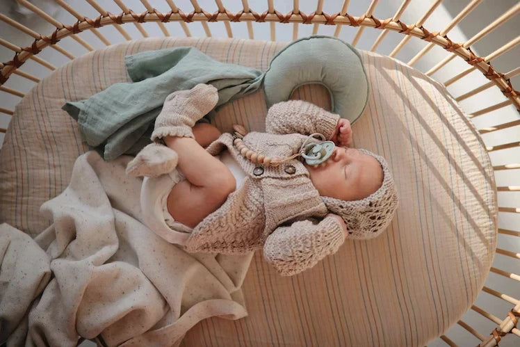 Baby Sleeping in Bassinet with Frigg Pacifier