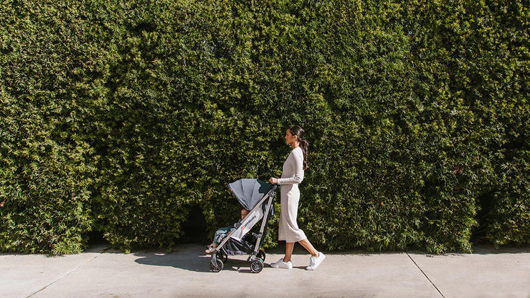 Woman Pushing Child in UPPAbaby G-Luxe Stroller