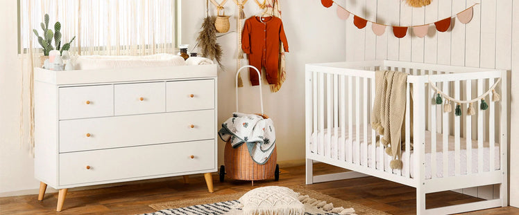 Baby Nursery with Crib and Dresser with Changing Table Top
