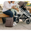 Changing bag on the ground next to Cruz stroller by Uppababy