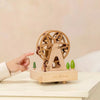 child playing with coco village wooden music box