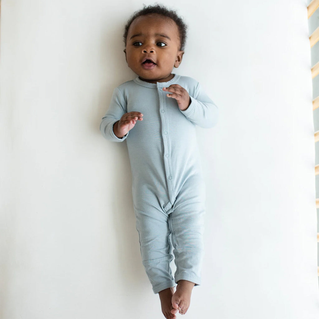 Cute baby wearing the Kyte Snap Romper in the color fog.