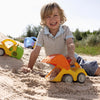 Kid having lots of fun in the sand with the orange and yellow sand play excavator.