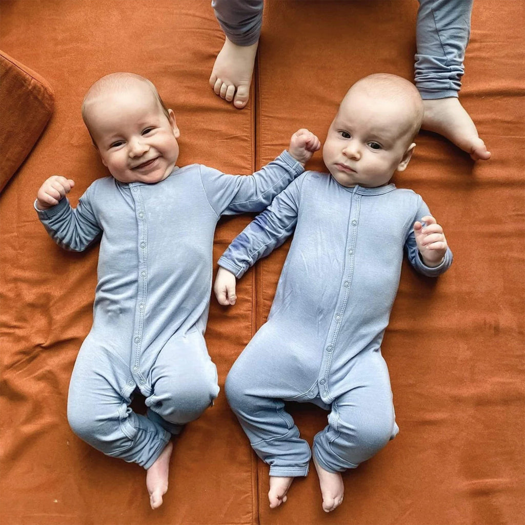 Twins wearing the cozy Kyte Snap Romper in the color Slate