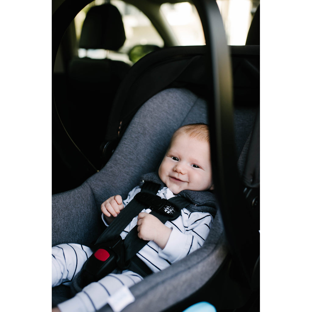 Baby buckled in the Clek best infant car seat comfortably.