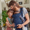 mom with daughter and carrying another child in best baby carrier by babybjorn