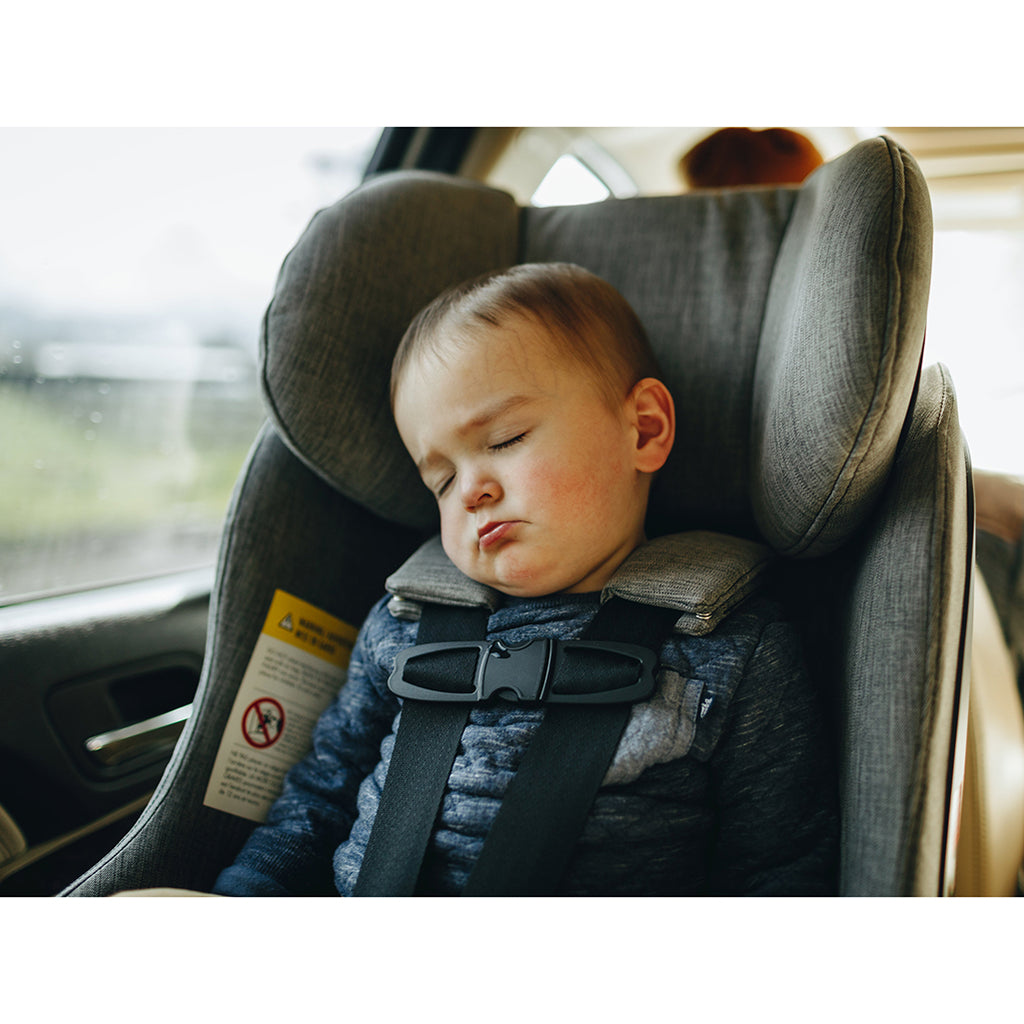 Child asleep in Clek Fllo best convertible car seat 2023