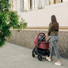 Mom Walking with Uppababy Cruz Stroller with Bassinet Accessory in Lucy