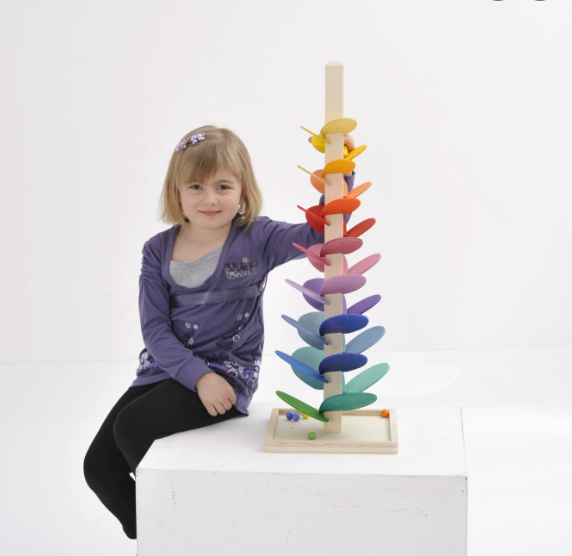 Girl Playing with BAJO Large Rainbow Marble Tree wood toy