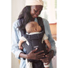 mom watching infant sleep in babybjorn carrier anthracite free