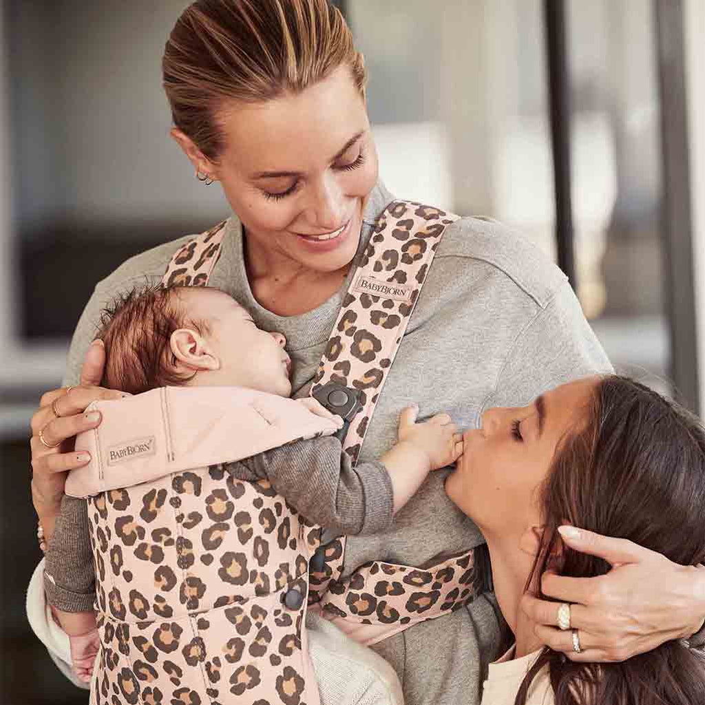 mom and daughter with baby sleeping in baby bjorn baby carrier mini leopard