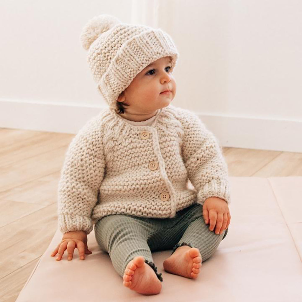 Huggalugs Natural Garter Stitch Cardigan Sweater modeled on infant.