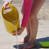 lifestyle_01 ekobu-pelican-bamboo-sand-bucket-childrens-eco-friendly-summer-toys - child pouring water out of bucket onto sand 