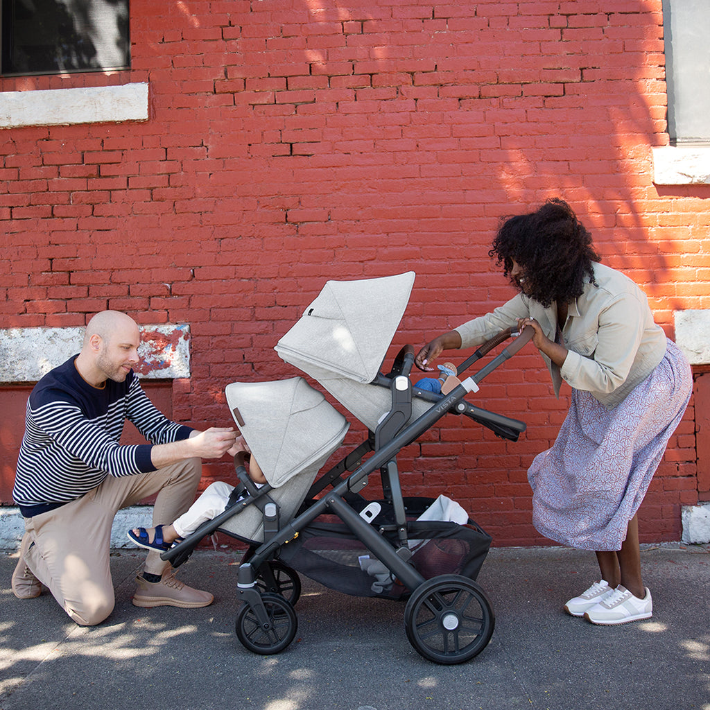 Parents using Uppababy vista stroller with Rumbleseats