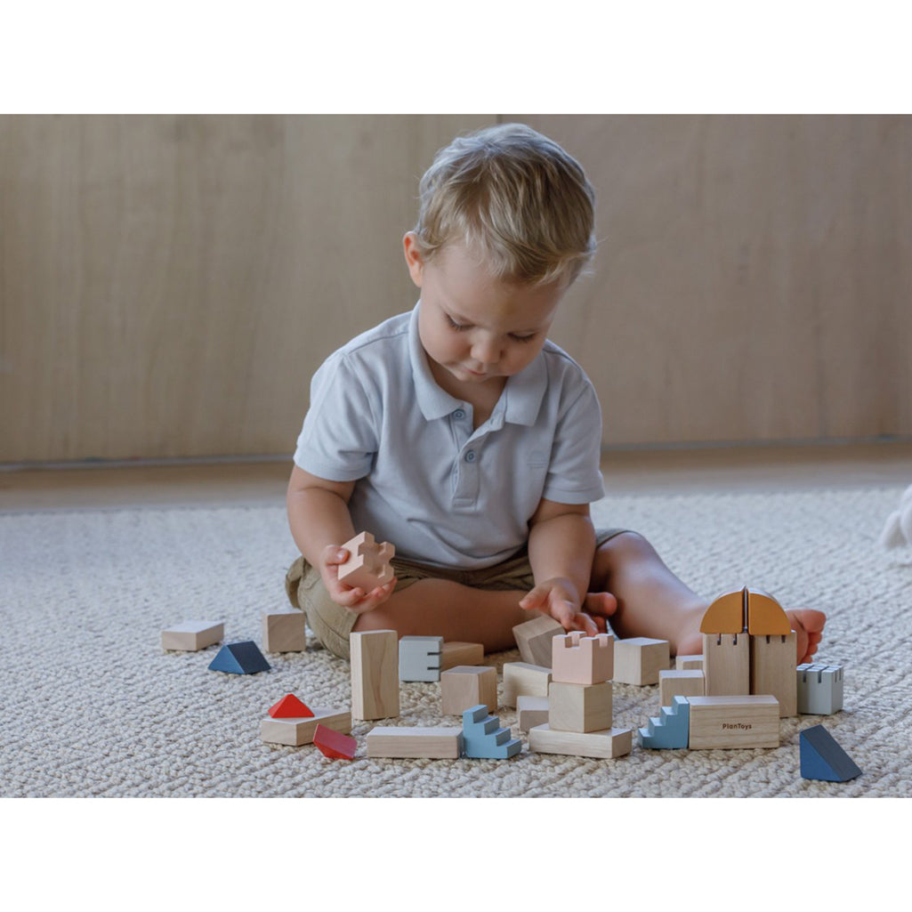 child playing with wooden blocks
