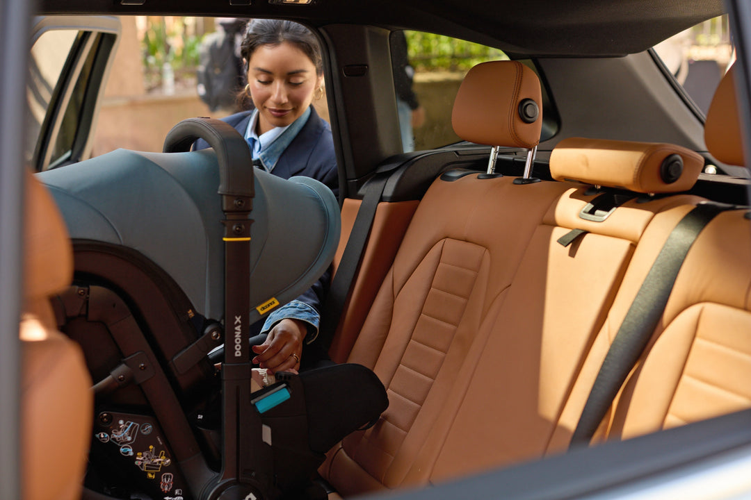 slate green doona x car seat on LATCH base 