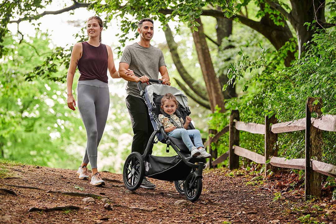 Parents strolling with jogging stroller