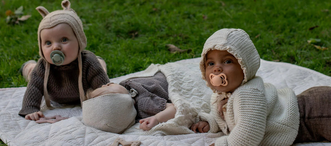 Babies playing outside with BIBS Pacifiers
