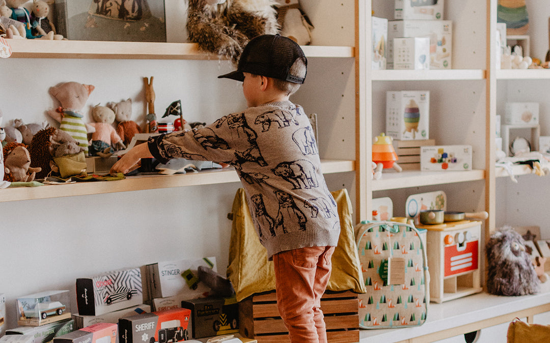 Toddler playing with children's wooden toys
