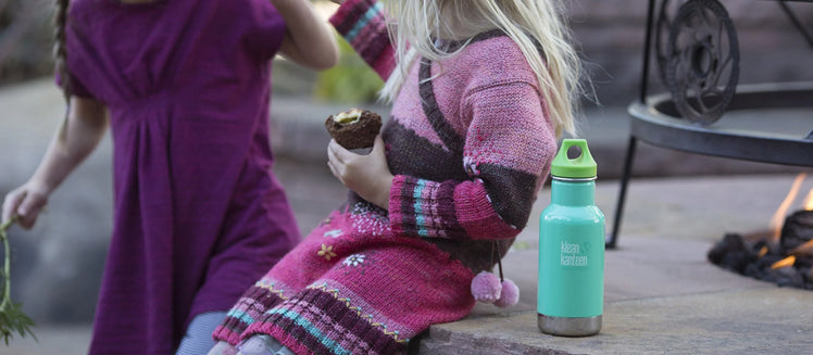 Kleen Kanteen Next to Young Girl Eating a Snack