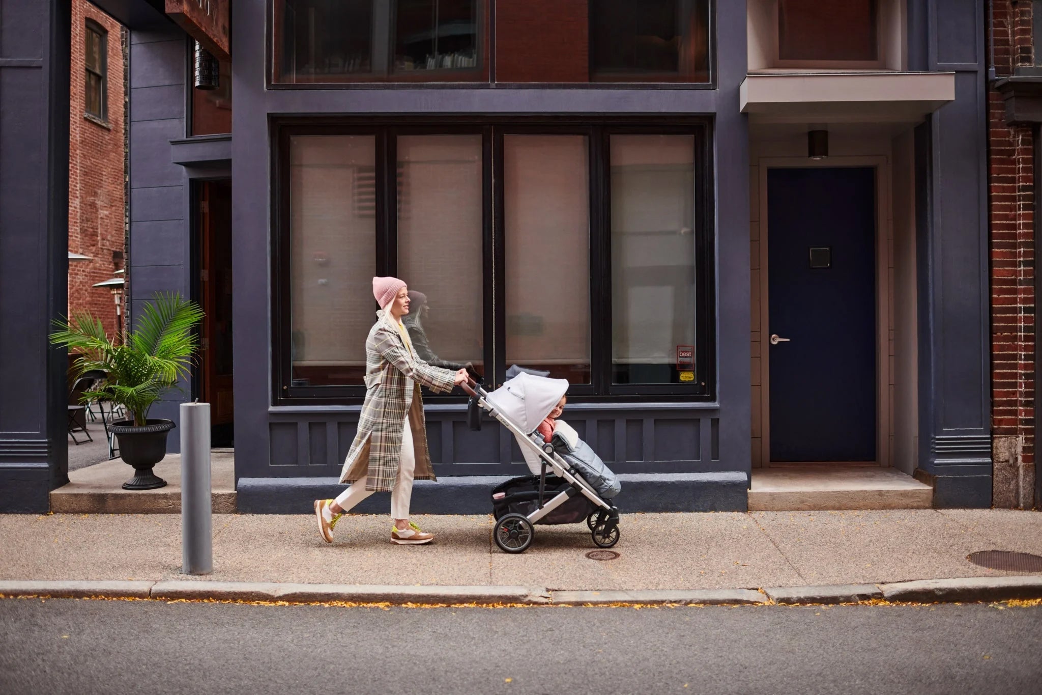 Woman Pushing Baby in UPPAbaby Stroller Down City Street