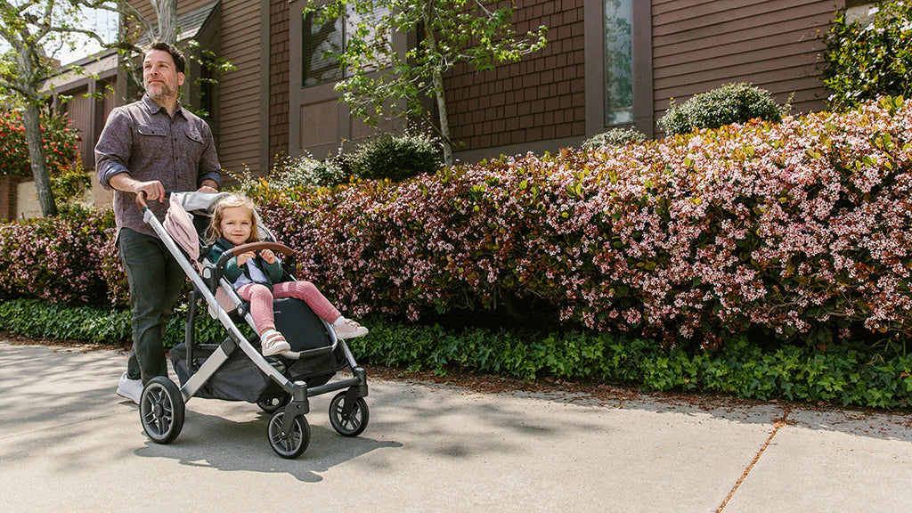 Dad Pushing Kid in UPPAbaby CRUZ Stroller in Neighborhood