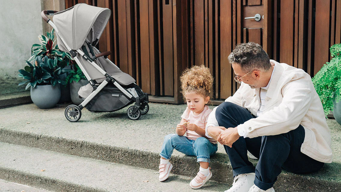 Dad and Daughter Talking on Steps with UPPAbaby Minu Stroller Behind Them