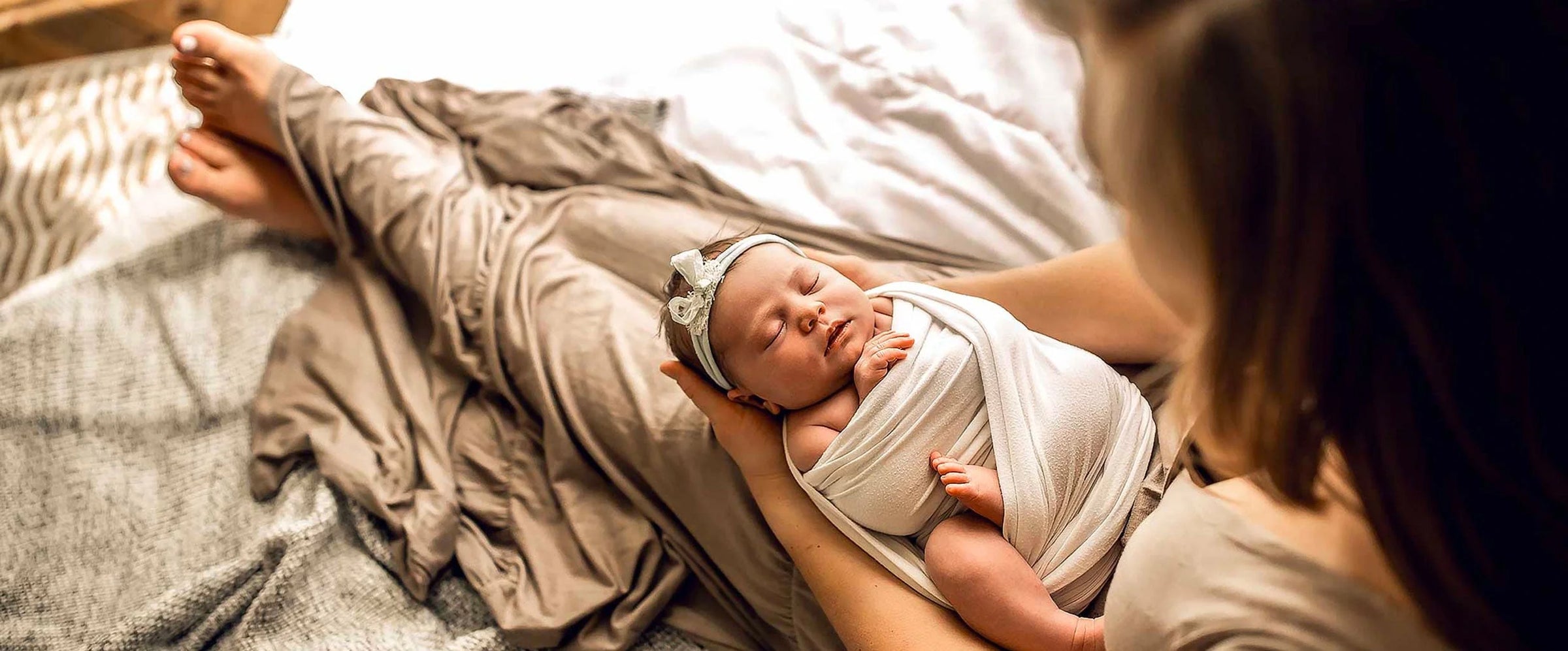 Mom Holding Swaddled Baby