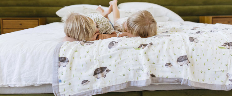 Two Kids Resting on Bed with Hedgehog Blanket