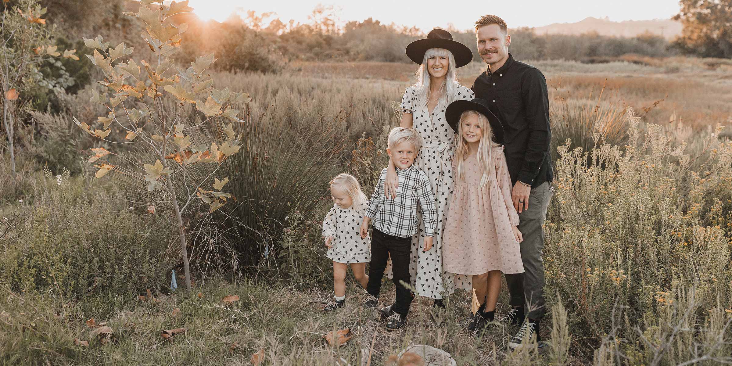 Family Posing in a Field in Rylee + Cru Clothing