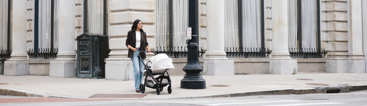 mother walking with toddler in uppbaby evelyn kona stroller