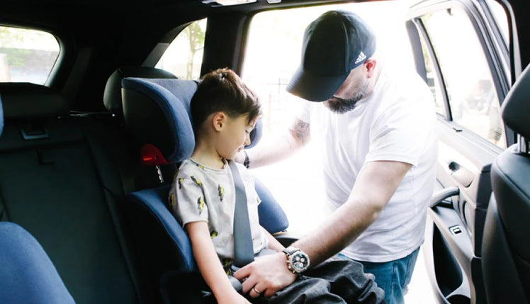 Dad Buckling Boy into Clek Booster Car Seat