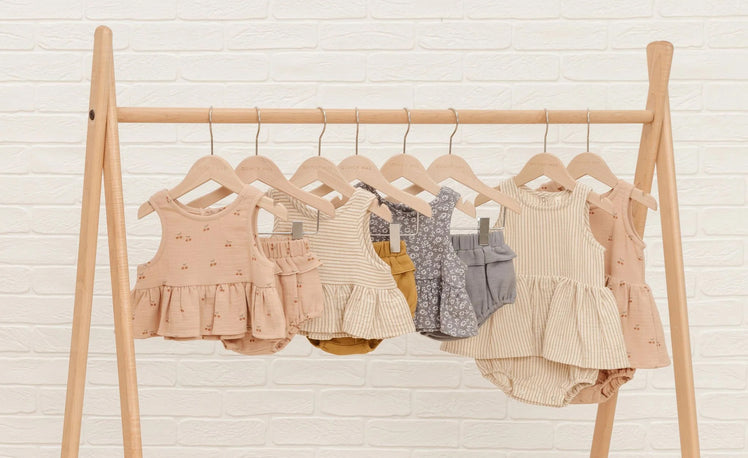 Baby Clothes Hanging on Clothing Rack
