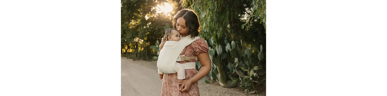 Mother Kissing Baby in Carrier