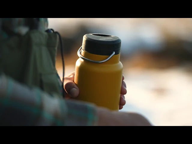 holding a Klean Kanteen insulated water bottle