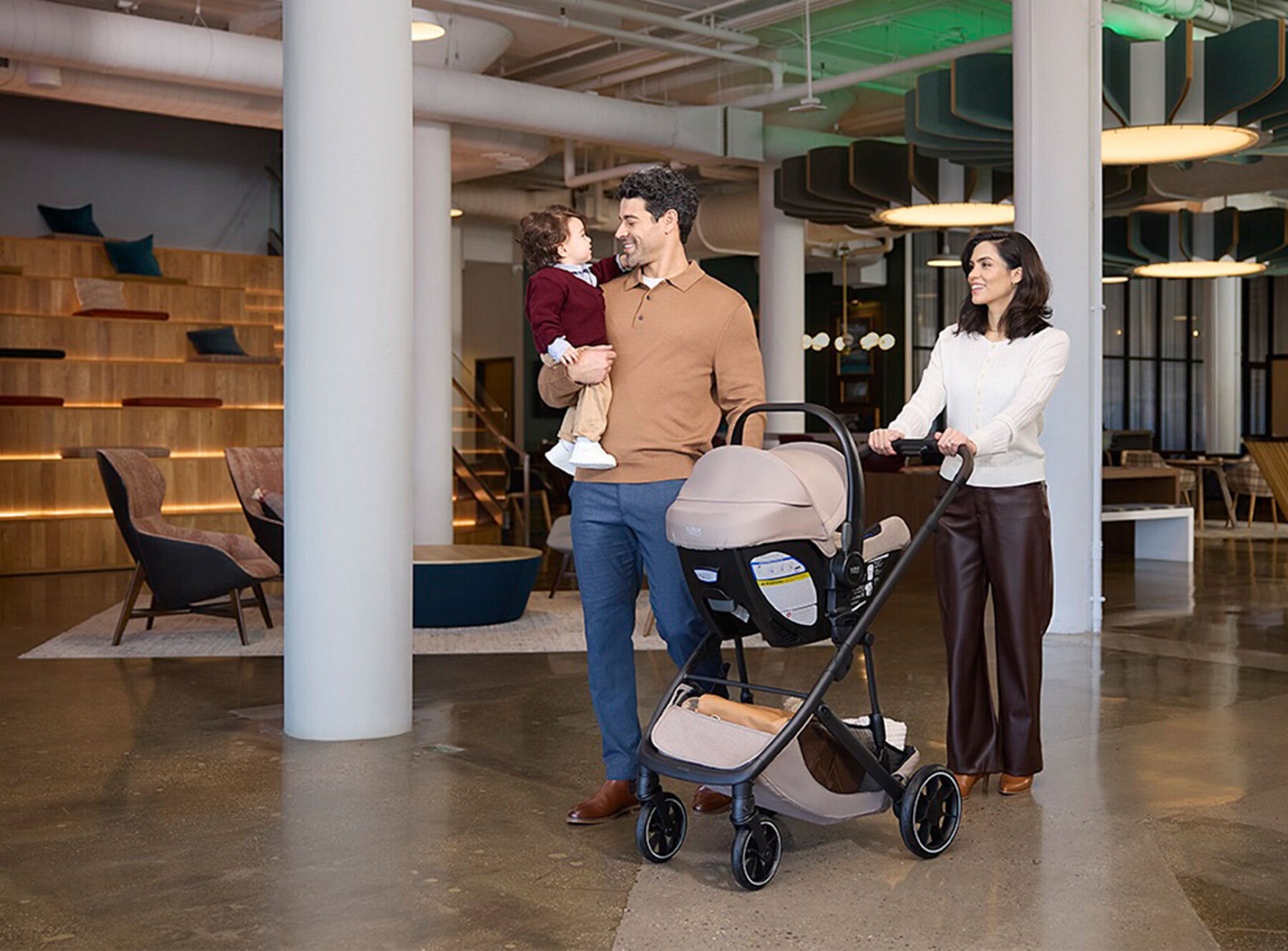 family with infant and toddler in public setting with britax travel system prism stroller and willow S infant car seat