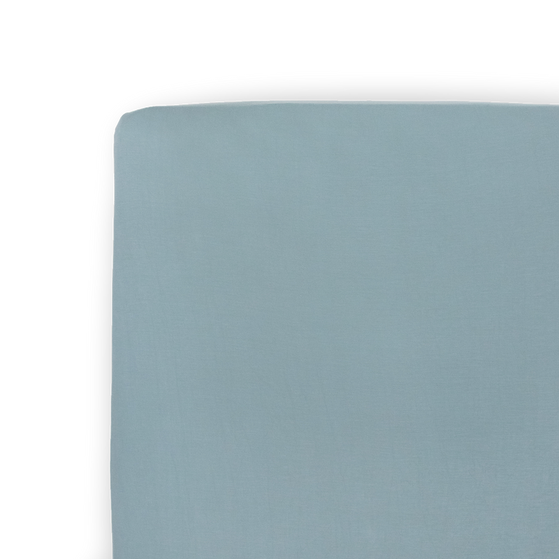 Folded neatly, the Little Unicorn Stretch Knit Crib Sheet in Harbor offers a soft and modern option for cozy crib sheets.