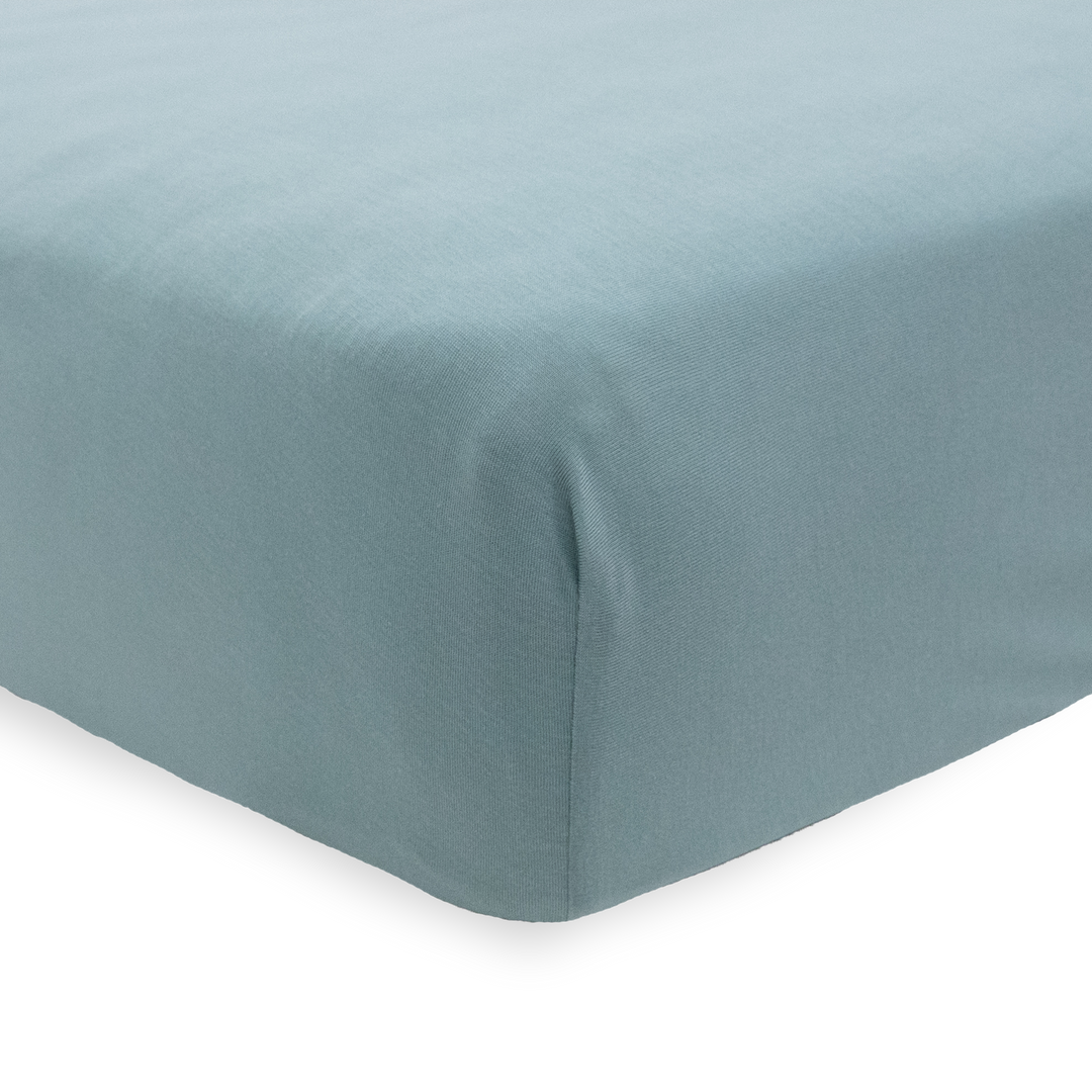 The Little Unicorn Stretch Knit Crib Sheet - Harbor fits snugly on the mattress, a stylish and durable fitted crib sheet.