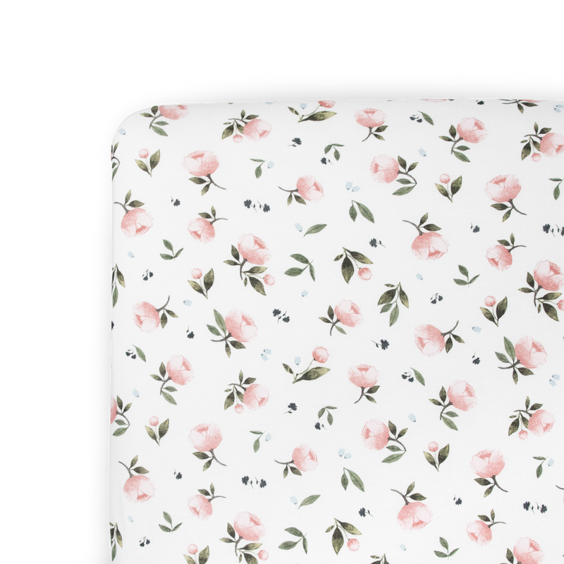 Folded neatly, the Little Unicorn Stretch Knit Crib Sheet in Watercolor Rose adds softness and beauty to any crib sheets collection.