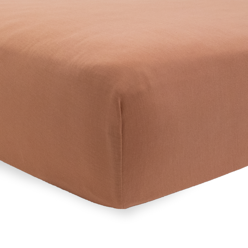 Terracotta Little Unicorn crib sheet showing stretch knit detail, premium organic crib sheets for boys and girls