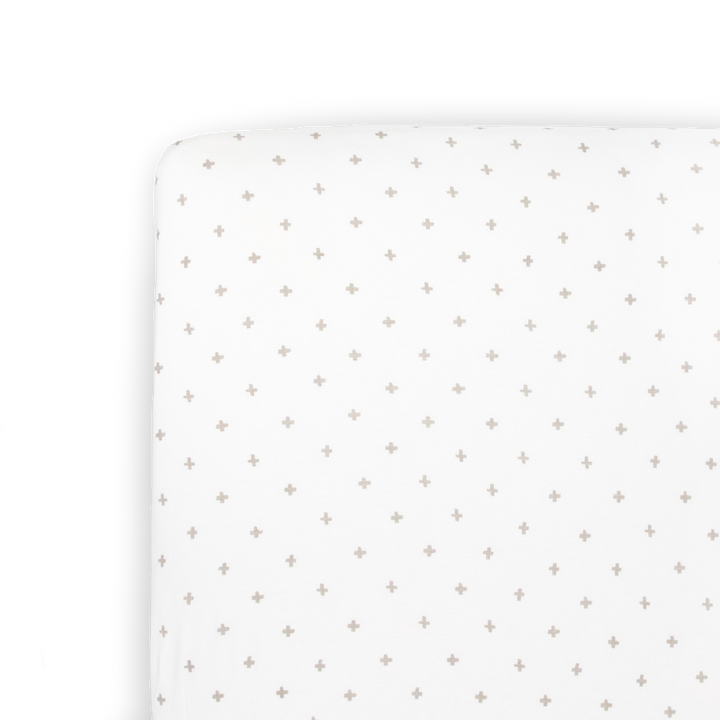 Little Unicorn Stretch Knit Crib Sheet in Grey Cross shown folded, a soft and stylish choice among crib sheets.