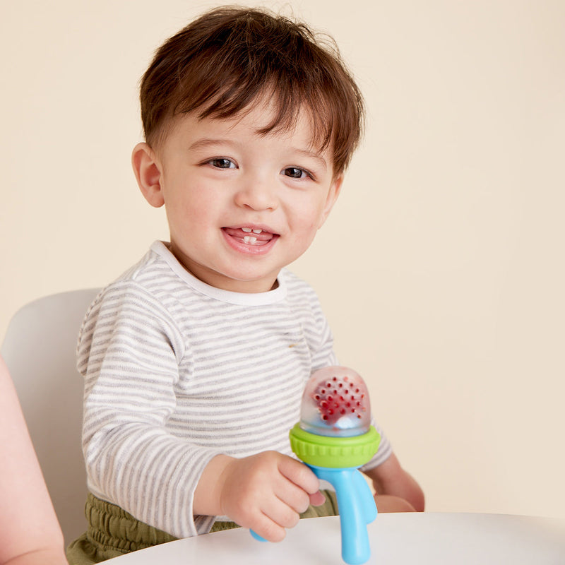 infant holding ocean breeze baby feeder