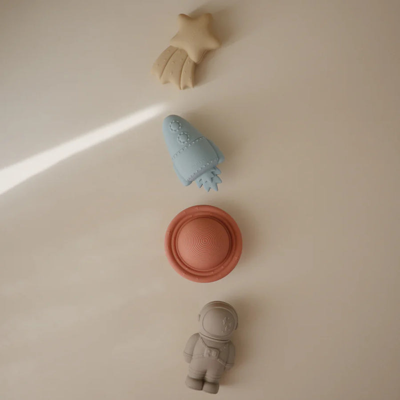 A collection of no-mold bath toys by Mushie designed with a space theme ideal for infants during bathtime