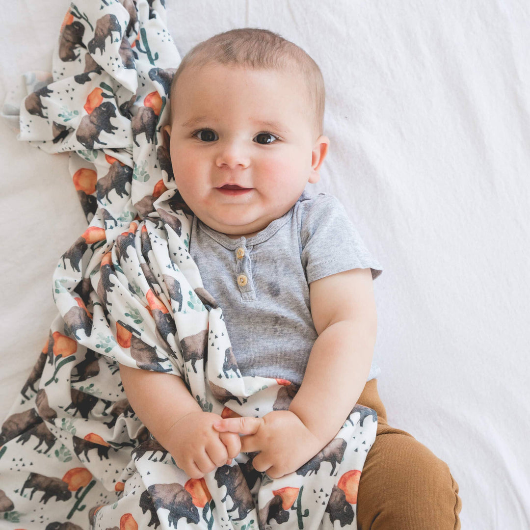 Copper Pearl Bison 46x46 muslin-style knit swaddle blanket in soft gender-neutral tones