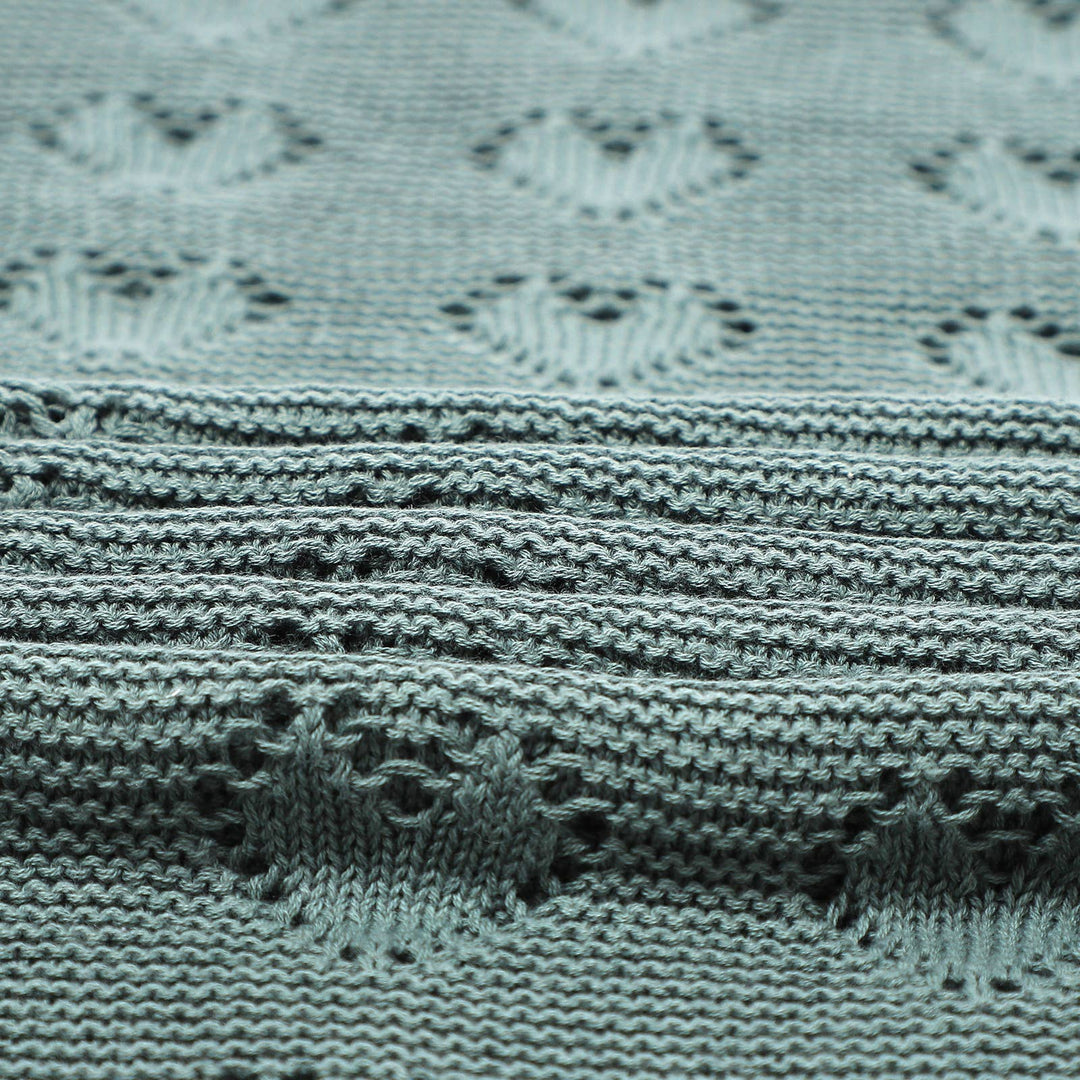 Close-up of Bleu La La Cotton Receiving Swaddle Baby Blanket with a Heart Pattern in Sage Green