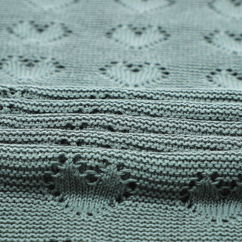 Close-up of Bleu La La Cotton Receiving Swaddle Baby Blanket with a Heart Pattern in Sage Green