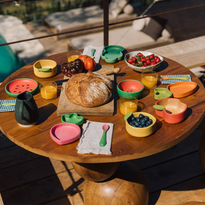 Oil & Carol Carrot and Radish spoons in picnic scene, baby feeding utensils for toddler meals, baby led weaning, and pretend play