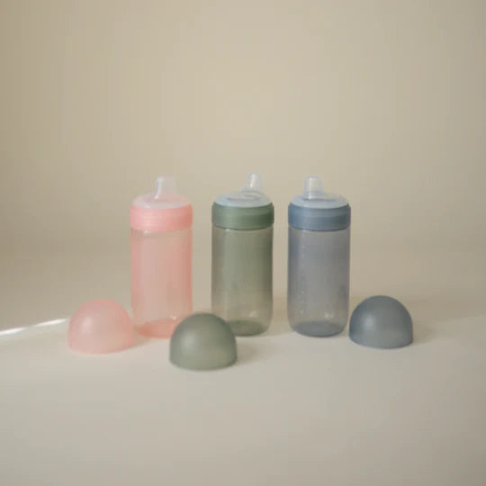 Mushie Soft Spout Sippy Cup flat lay August - three colorway sippy cups displayed on neutral background