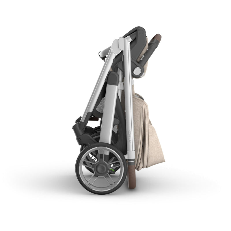 Compact folded uppa baby  Cruz V3 Stroller in Declan finish, demonstrating one handed fold for easy storage and transport
