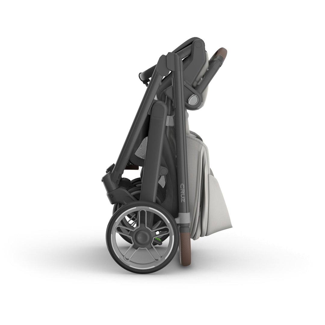 Compact folded Uppababy v3 stroller cruz Savannah, showing one handed fold and easy transport capability